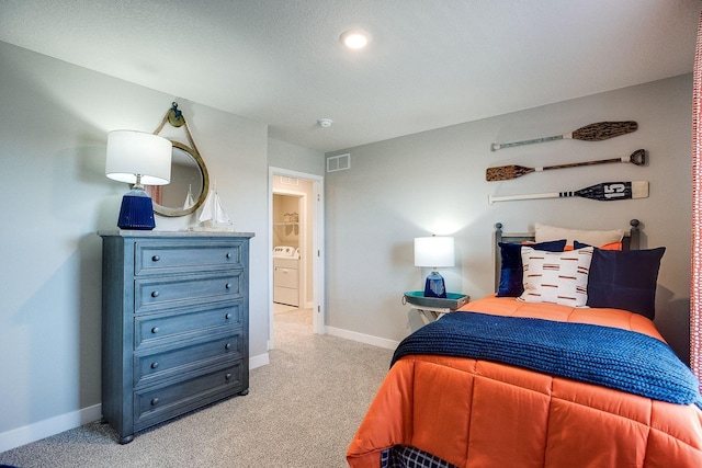 bedroom with light carpet, washer / clothes dryer, visible vents, and baseboards