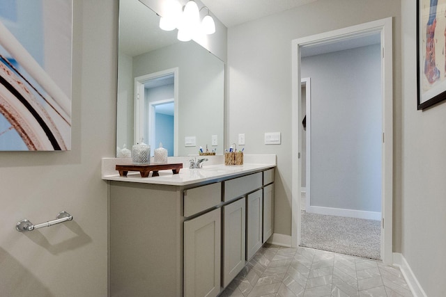 bathroom with vanity and baseboards