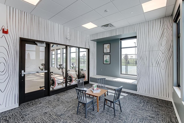 interior space featuring french doors, visible vents, a drop ceiling, baseboards, and wallpapered walls