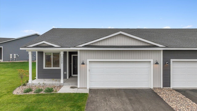 ranch-style home featuring a garage and a front lawn