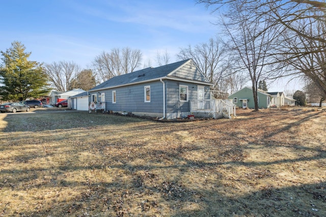 view of side of home featuring a yard and a garage