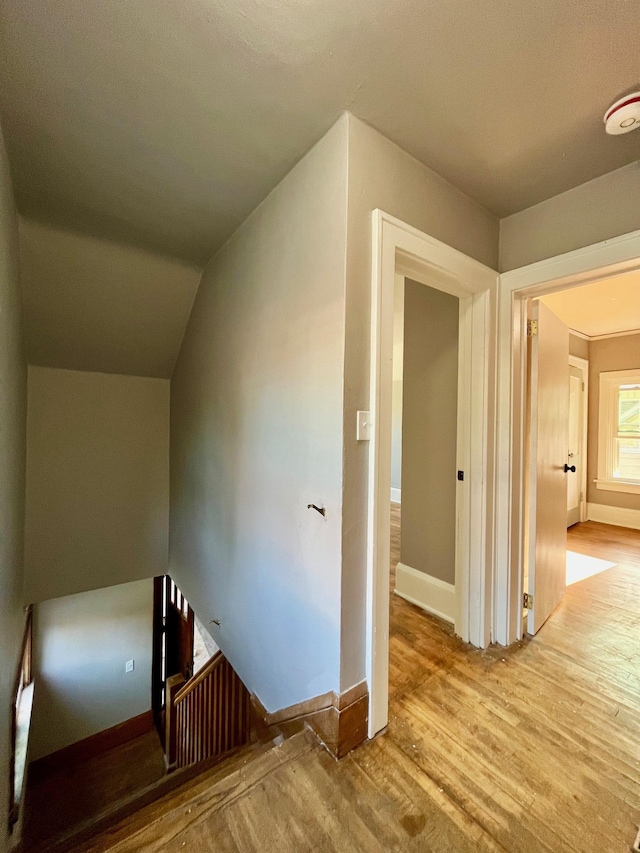 stairway with hardwood / wood-style flooring and vaulted ceiling