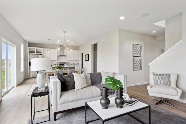 living room featuring light hardwood / wood-style floors and an inviting chandelier