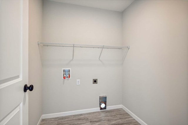 washroom with hookup for an electric dryer, hardwood / wood-style flooring, and washer hookup