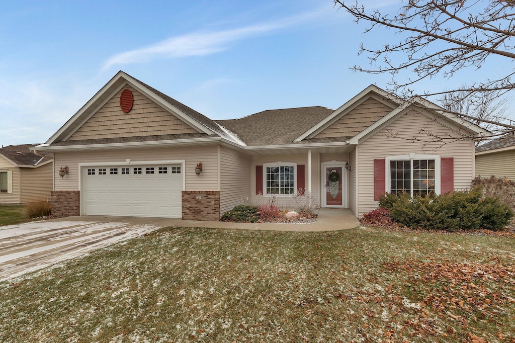 view of front facade with a garage and a front lawn