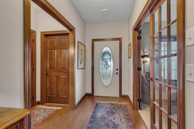 doorway with french doors and light hardwood / wood-style flooring