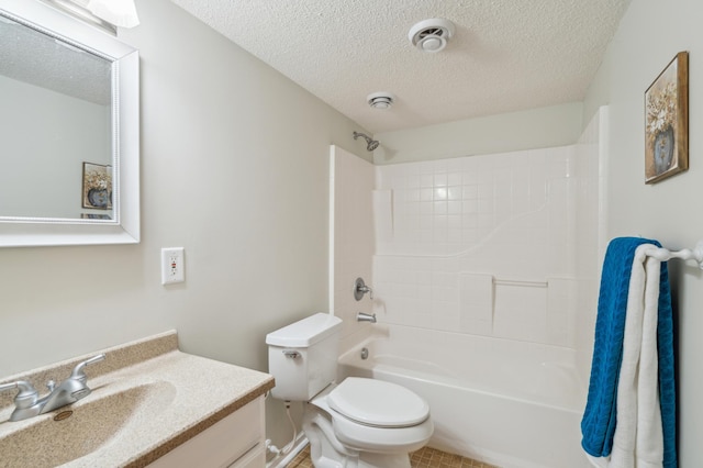 bathroom with shower / bath combination, toilet, vanity, and a textured ceiling