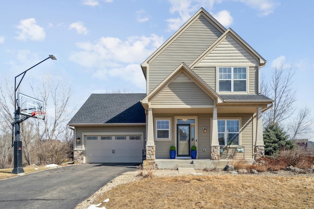 craftsman inspired home with roof with shingles, an attached garage, covered porch, stone siding, and aphalt driveway