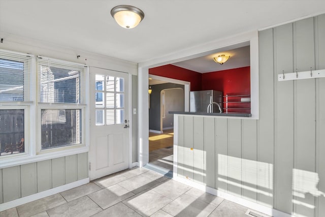 doorway with light tile patterned flooring