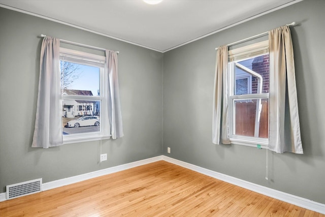 unfurnished room featuring hardwood / wood-style flooring