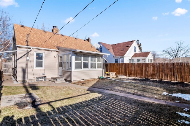 back of property with a sunroom