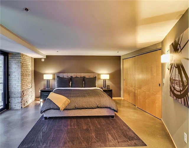 bedroom featuring a closet and concrete floors