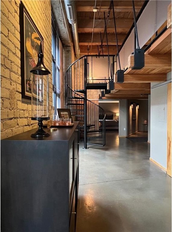 interior space with concrete floors, wooden ceiling, and beamed ceiling