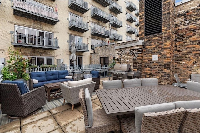 view of patio with an outdoor living space and a grill