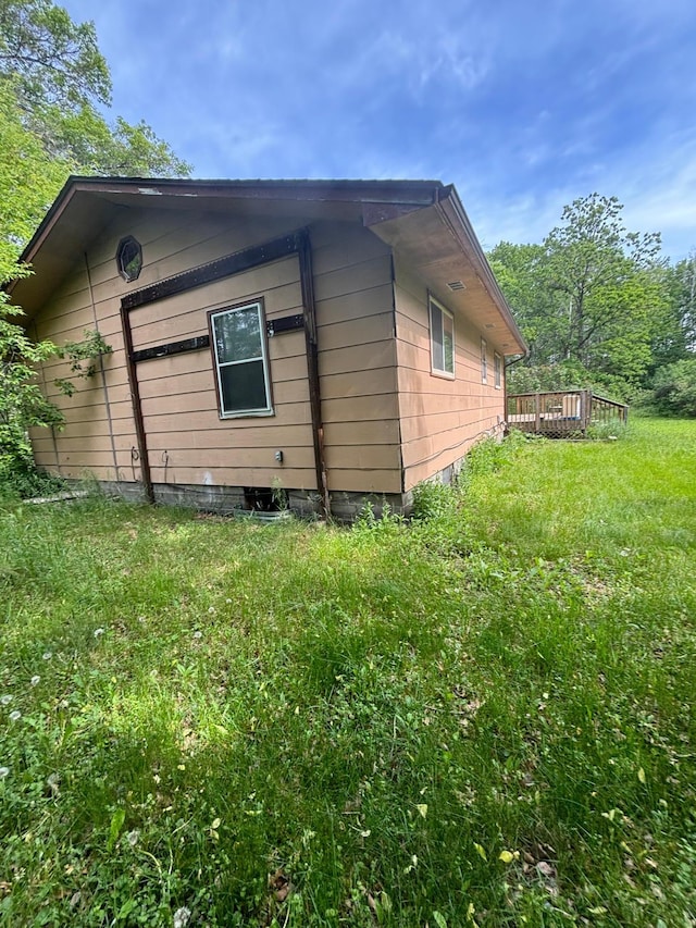 view of home's exterior with a yard and a deck