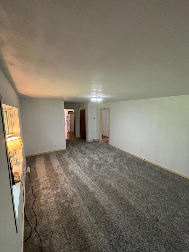 unfurnished bedroom featuring dark colored carpet