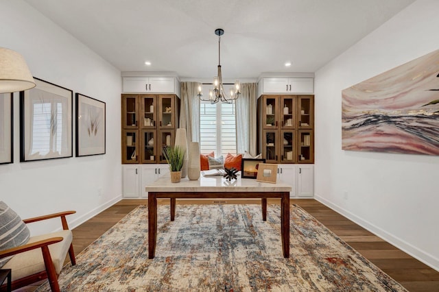 office area featuring a notable chandelier and dark hardwood / wood-style floors