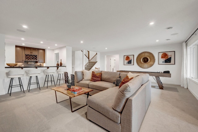 carpeted living room featuring indoor bar