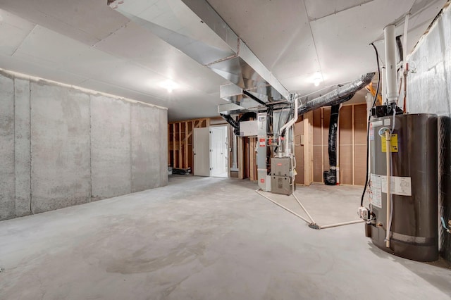 basement featuring heating unit and water heater