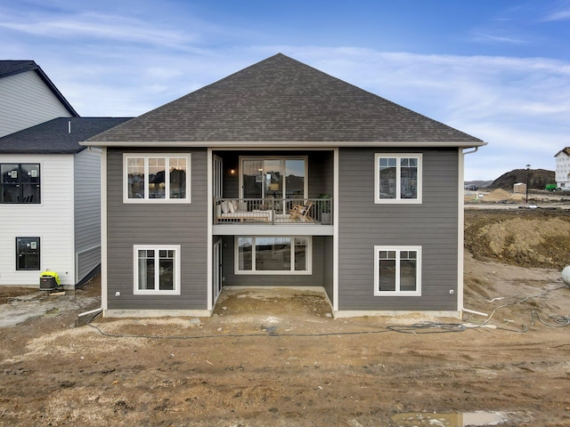 back of property featuring a balcony