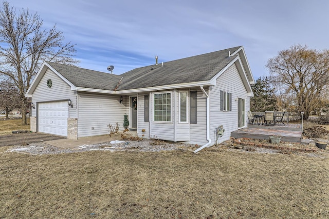 view of front of property with a wooden deck, a front lawn, and a garage