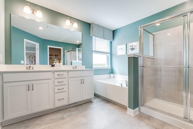 bathroom with vanity and independent shower and bath