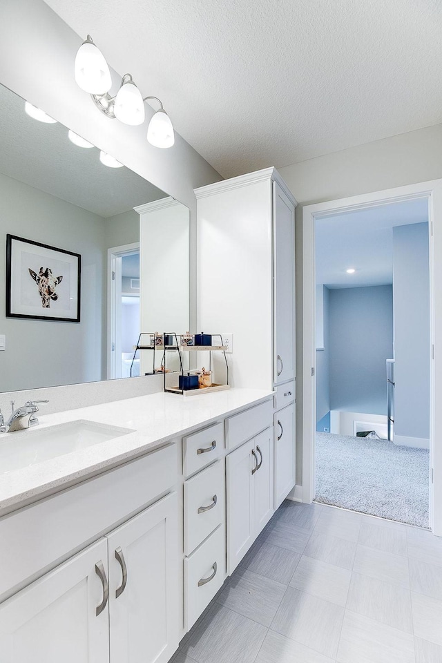 bathroom with vanity and a textured ceiling