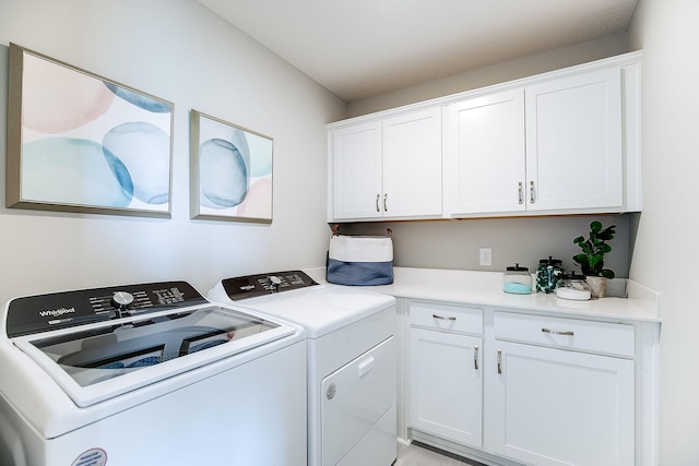 laundry room with cabinets and washing machine and clothes dryer