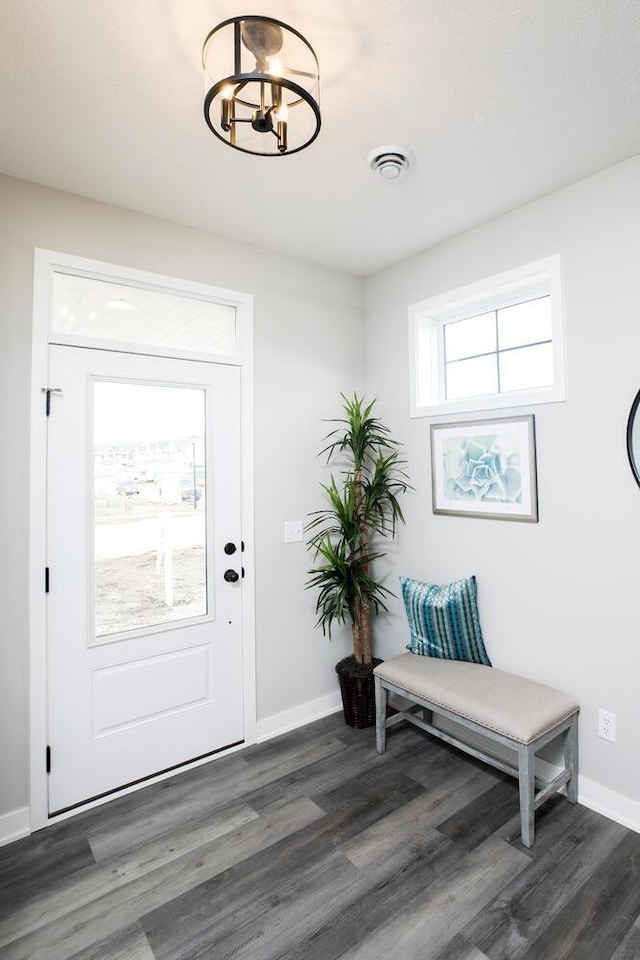 entrance foyer with dark hardwood / wood-style floors and a chandelier