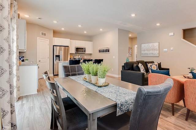 dining room featuring light hardwood / wood-style flooring and sink