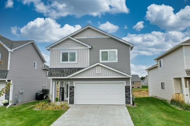 view of front of home with a front yard and a garage