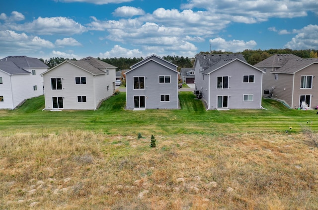 rear view of property with a yard