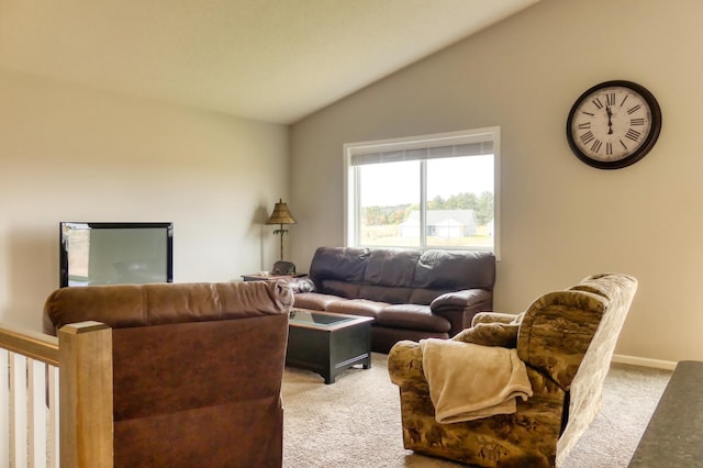 carpeted living room featuring vaulted ceiling