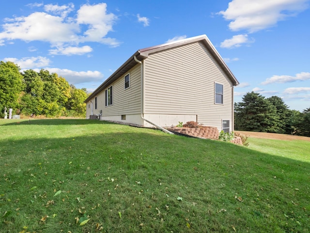 view of side of home featuring a lawn