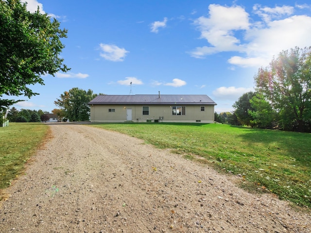 rear view of house featuring a yard