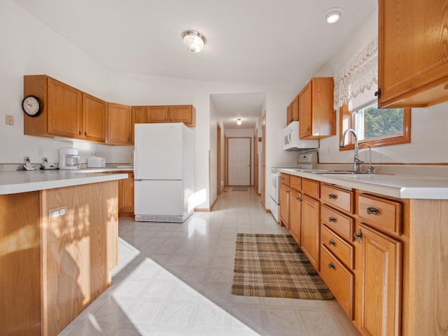 kitchen featuring sink and white appliances