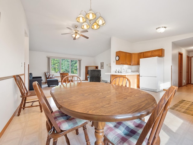 dining space featuring ceiling fan with notable chandelier