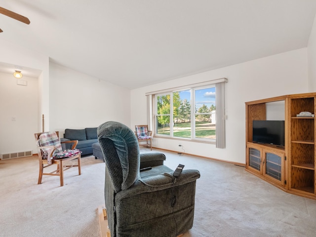 carpeted living room featuring ceiling fan