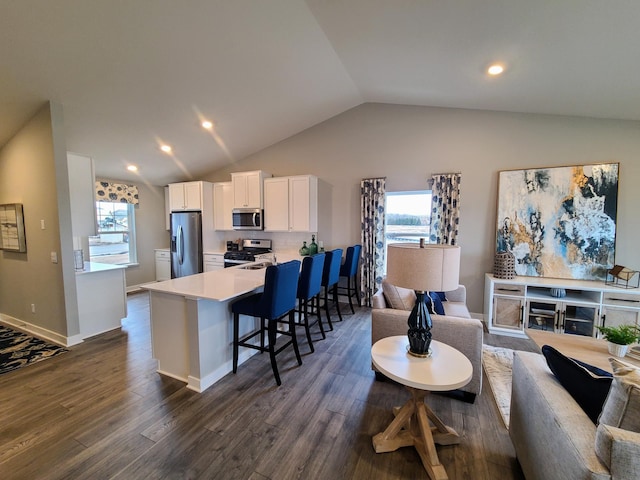 living room featuring dark hardwood / wood-style floors and vaulted ceiling