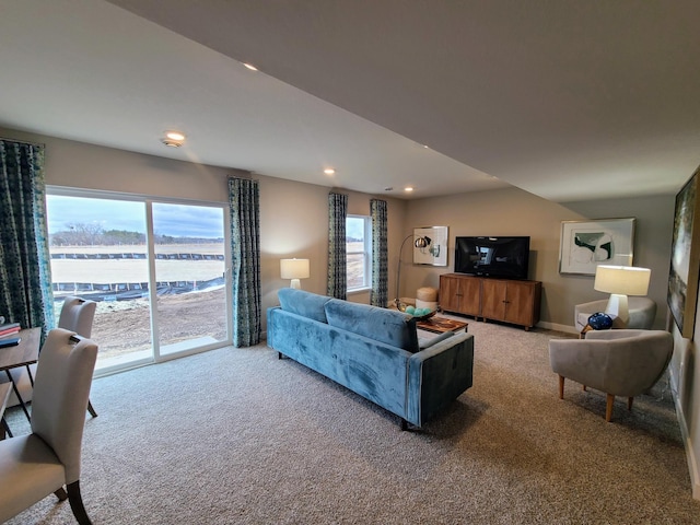 living room featuring a water view and carpet floors