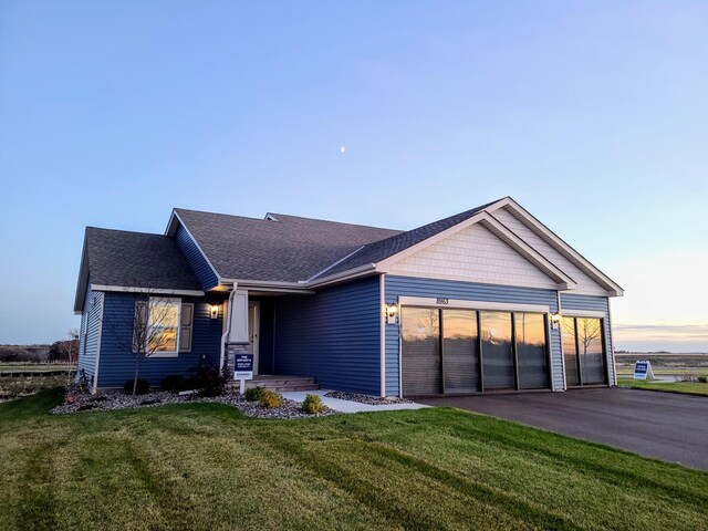 view of front of house featuring a yard and a garage