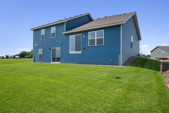 rear view of house featuring a yard