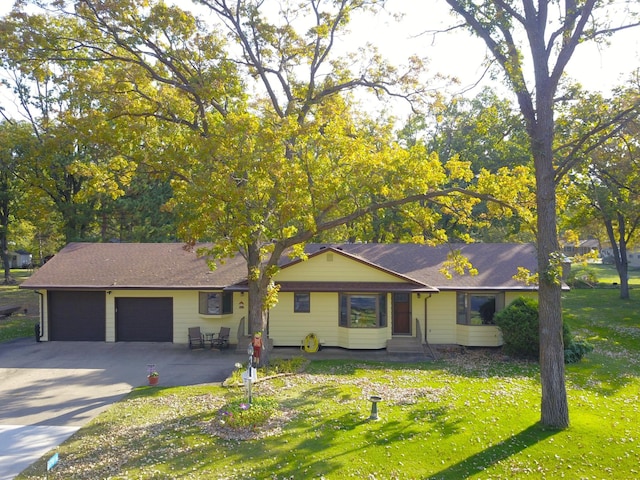 single story home featuring a front lawn and a garage