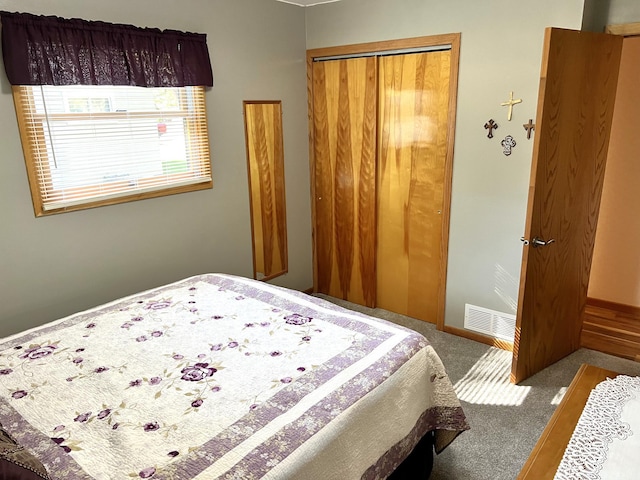 bedroom with carpet and a closet