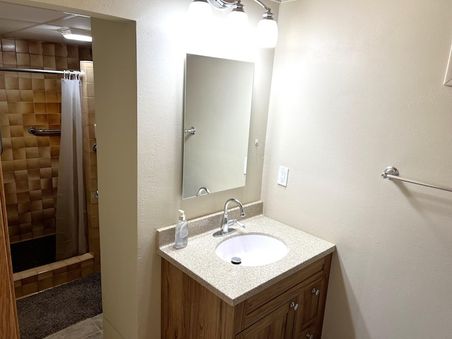 bathroom featuring tile patterned floors, vanity, and walk in shower