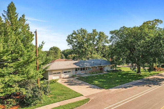 single story home featuring a front yard and a garage