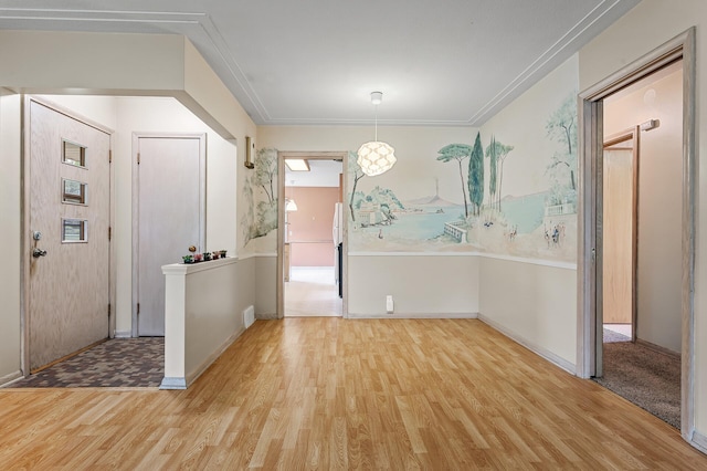 foyer featuring hardwood / wood-style floors and ornamental molding