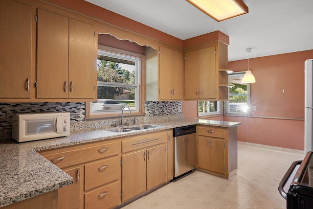 kitchen with pendant lighting, dishwasher, range, sink, and kitchen peninsula