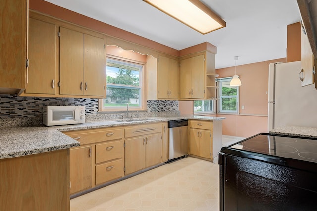 kitchen featuring light stone countertops, sink, hanging light fixtures, tasteful backsplash, and white appliances