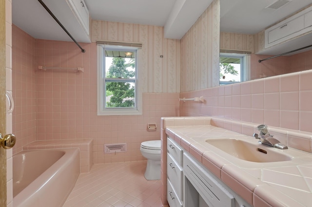 full bathroom with tile patterned flooring, vanity, plenty of natural light, and toilet